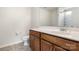 Bathroom featuring wood cabinetry, a white sink, and a large mirror at 4714 Adamshire Ave, Concord, NC 28025