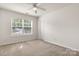 Bright bedroom featuring neutral carpeting and a large window at 4714 Adamshire Ave, Concord, NC 28025