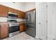Modern kitchen featuring stainless steel appliances and wooden cabinets at 4714 Adamshire Ave, Concord, NC 28025