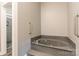 Modern bathroom featuring a luxurious tub with handrails and a separate walk-in shower at 502 Lake Club Dr, Rock Hill, SC 29732
