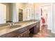 Bathroom featuring double sinks, walk-in shower and a view into the walk-in closet at 502 Lake Club Dr, Rock Hill, SC 29732