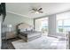 Main bedroom with view into office, ceiling fan, and lake view at 502 Lake Club Dr, Rock Hill, SC 29732