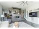 Open living room with a fireplace, ceiling fan, and view into the kitchen at 502 Lake Club Dr, Rock Hill, SC 29732