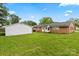 A spacious backyard features a brick home, white detached garage, and a lush lawn at 505 Melody Ln, Shelby, NC 28152