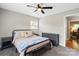 Bedroom featuring a ceiling fan, windows, and carpeted floor at 505 Melody Ln, Shelby, NC 28152