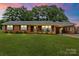 Charming brick home featuring a large front yard and covered parking at 505 Melody Ln, Shelby, NC 28152