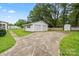 A detached two-car garage with a concrete driveway sits next to a well-maintained lawn at 505 Melody Ln, Shelby, NC 28152