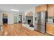 Open kitchen with fireplace, stainless appliances, and access to the laundry area at 505 Melody Ln, Shelby, NC 28152