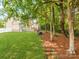 This is a spacious backyard with mature trees and a well-maintained lawn, perfect for outdoor activities at 537 Montgrove Nw Pl, Concord, NC 28027