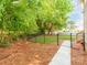Fenced backyard that provides privacy and security, complemented by lush green trees and natural ground cover at 537 Montgrove Nw Pl, Concord, NC 28027