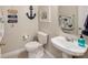 Charming powder room featuring coastal decor, a pedestal sink, and tiled flooring at 537 Montgrove Nw Pl, Concord, NC 28027