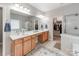 Bathroom boasts double sinks, a large mirror, and access to the walk-in closet and shower at 537 Montgrove Nw Pl, Concord, NC 28027