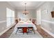 Traditional dining room with hardwood floors, a chandelier, and seating for six, perfect for Gathering gatherings at 537 Montgrove Nw Pl, Concord, NC 28027
