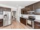 Bright kitchen with stainless steel appliances, modern cabinets, and access to the dining room at 537 Montgrove Nw Pl, Concord, NC 28027