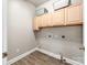 Functional laundry room with overhead cabinets and ample space for storage at 537 Montgrove Nw Pl, Concord, NC 28027