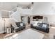 Open-concept living area with hardwood floors, a staircase, and seamless access to the kitchen, ideal for entertaining at 537 Montgrove Nw Pl, Concord, NC 28027