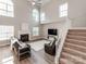 Spacious living room with a fireplace, large windows, and hardwood floors, creating an inviting atmosphere at 537 Montgrove Nw Pl, Concord, NC 28027