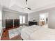 Bright main bedroom boasts a trey ceiling, wood floors, and access to the ensuite bathroom at 537 Montgrove Nw Pl, Concord, NC 28027