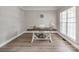 Bright home office with hardwood floors, a stylish desk, a decorative clock, and abundant natural light at 537 Montgrove Nw Pl, Concord, NC 28027