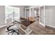 Inviting home office featuring hardwood floors, modern decor, and elegant French doors leading to the dining room at 537 Montgrove Nw Pl, Concord, NC 28027