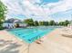 Community pool with lounge chairs and umbrellas is a fantastic amenity for residents to enjoy at 537 Montgrove Nw Pl, Concord, NC 28027