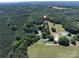 Expansive aerial view of a country estate featuring lush forests and open fields at 5410 A R Gordon Rd, Waxhaw, NC 28173