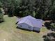 Aerial view of a single-story home with a gray roof surrounded by a lush green lawn and mature trees at 5410 A R Gordon Rd, Waxhaw, NC 28173