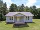 Charming home exterior with a cozy porch and well-manicured front lawn at 5410 A R Gordon Rd, Waxhaw, NC 28173
