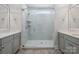 Modern bathroom showcasing a glass shower with a built-in seat, dual sinks, and sleek finishes at 5590 Elk Knob Ct, Denver, NC 28037