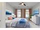 Bright staged bedroom with three windows, ceiling fan, and modern decor at 5590 Elk Knob Ct, Denver, NC 28037