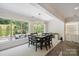 Bright dining area with a modern chandelier and beautiful views to the outdoor living spaces at 5590 Elk Knob Ct, Denver, NC 28037