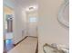 Bright foyer with hardwood floors, a front door with glass windows and a decorative mirror at 5590 Elk Knob Ct, Denver, NC 28037