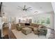 Open-concept living room featuring a large sectional sofa, access to back porch, and modern kitchen at 5590 Elk Knob Ct, Denver, NC 28037