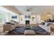 Well-lit living room with a fireplace, built-in shelves, and comfortable seating arrangement at 5590 Elk Knob Ct, Denver, NC 28037