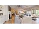 Open-concept living room with a modern kitchen, dining area, and access to the outdoors at 5590 Elk Knob Ct, Denver, NC 28037