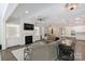 Spacious living room with a fireplace, TV, and open access to the kitchen and dining areas at 5590 Elk Knob Ct, Denver, NC 28037