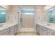 Main bathroom with a glass shower and double vanities at 5590 Elk Knob Ct, Denver, NC 28037