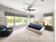 Bright main bedroom with a ceiling fan, large windows and a king bed at 5590 Elk Knob Ct, Denver, NC 28037