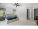 Spacious main bedroom featuring a ceiling fan, neutral walls, carpeted floors, and ensuite bathroom at 5590 Elk Knob Ct, Denver, NC 28037