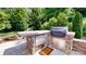 Stone-built outdoor kitchen with stainless steel grill and beverage fridge at 5590 Elk Knob Ct, Denver, NC 28037