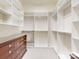 Walk-in closet featuring custom shelving and a wooden dresser at 5590 Elk Knob Ct, Denver, NC 28037