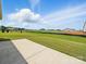 A concrete patio extends into a sprawling backyard, offering a serene outdoor living space at 6015 Waldorf Ave, Monroe, NC 28110
