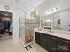 Modern bathroom featuring a glass shower with a seat, and a dual sink vanity at 6015 Waldorf Ave, Monroe, NC 28110