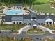 An aerial shot shows the community clubhouse with a pool, parking, and beautiful landscaping at 6015 Waldorf Ave, Monroe, NC 28110