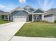 Charming home with blue siding, a well-manicured lawn, and a two-car garage at 6015 Waldorf Ave, Monroe, NC 28110