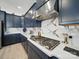 Close up on luxury kitchen features, including a marble backsplash and stainless steel stovetop at 6015 Waldorf Ave, Monroe, NC 28110