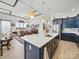 Open-concept kitchen with a large island and seating, flowing into a dining and living area at 6015 Waldorf Ave, Monroe, NC 28110