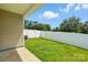 Fenced backyard with green grass and an air conditioning unit, offering a private outdoor space at 6333 Cory Bret Ln, Charlotte, NC 28278