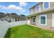 Backyard features a well-kept lawn, white fence, and the side of the home, creating a private area at 6333 Cory Bret Ln, Charlotte, NC 28278