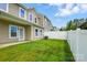 Private backyard with green lawn, white fence, and access to the house at 6333 Cory Bret Ln, Charlotte, NC 28278